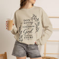 Soft crewneck sweatshirt with hand-lettered 'Don't Worry About Tomorrow, God Is Already There' faith message and laurel frame.