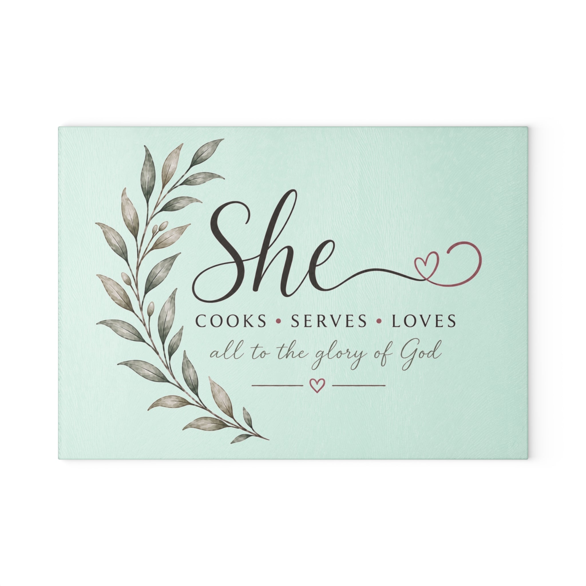 Decorative sign with text 'She cooks, serves, loves all to the glory of God' on a light green background | FaithfulFindsNZ
