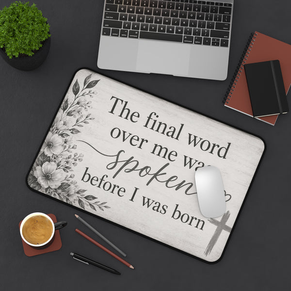 Desk setup with a decorative mouse pad featuring text and floral design, laptop, coffee cup, and office supplies | Faithful Finds