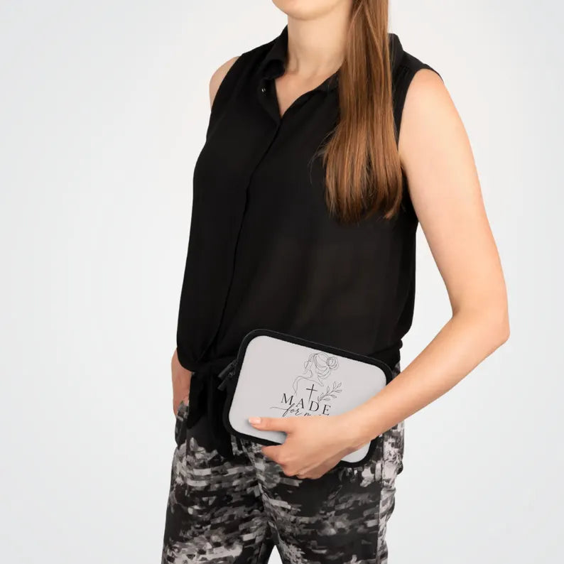 Person holding a blue clutch bag with a design on a plain background | FaithfulFindsNZ